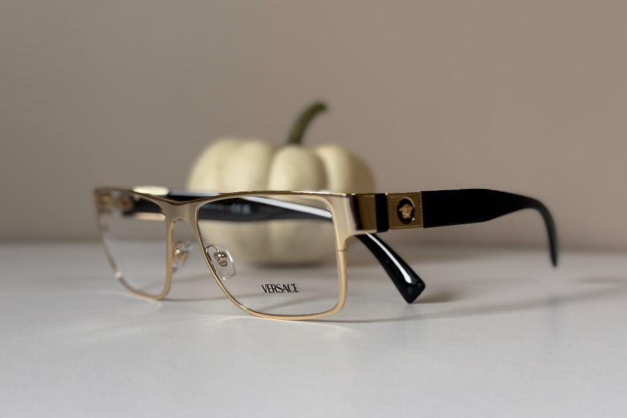 Versace designer men's eyeglass frame in gold with brown temples VE1274